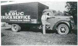 A decades-old photograph of young Alex Klak with his first delivery truck; Leduc Truck Service's fleet unit number 000001