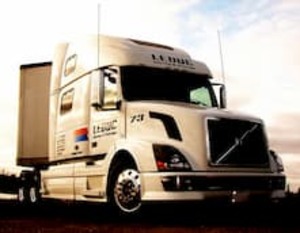 The cab of a Leduc Truck Service transport vehicle gleaming in the sun